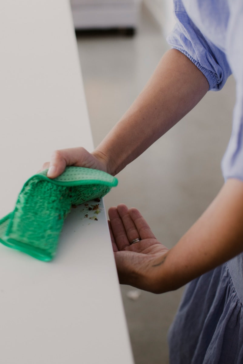 Person cleaning kitchen benchtop in kitchen with ENJO Kitchen Allpurpose Cloth