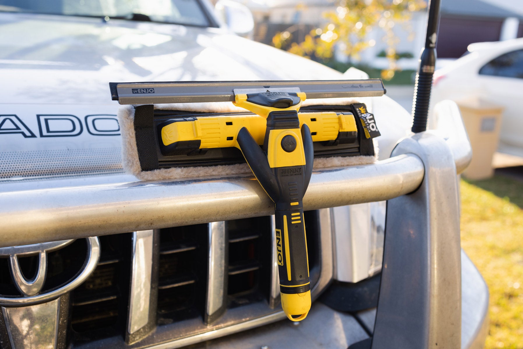 Multi Tool with Car Multi Tool Fibre resting on car front bumper