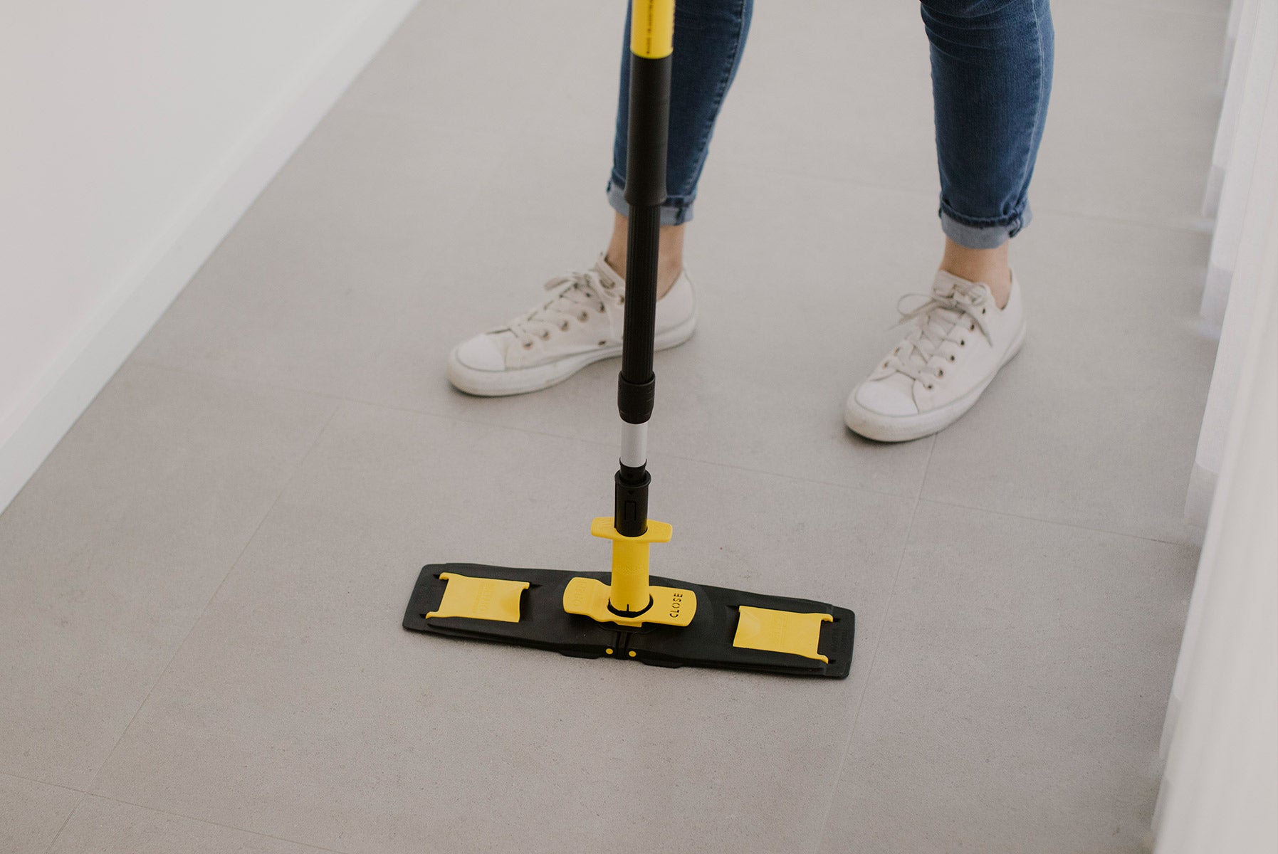 Floorcleaner in parked position with person standing behind