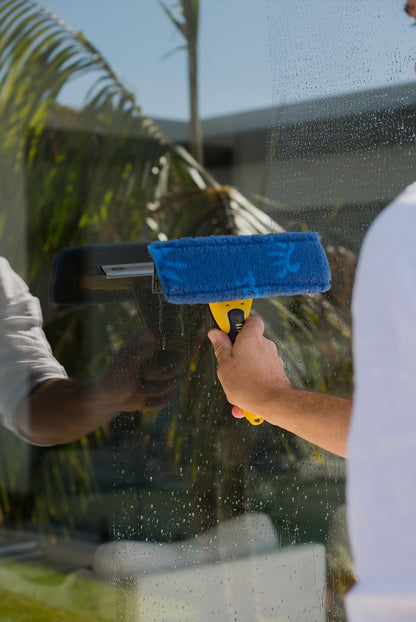 Person cleaning pool glass door with ENJO Window Multi Tool