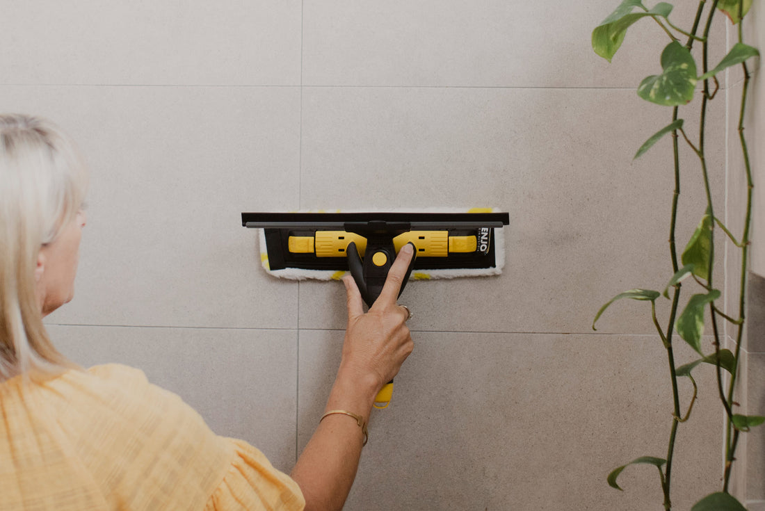 Person cleaning shower in bathroom with ENJO Bathroom Multi Tool Fibre