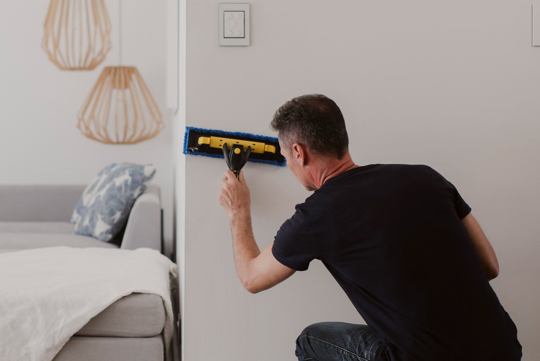 Person cleaning wall with ENJO Living Multi Tool