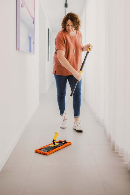Person sweeping tiled floors with ENJO Dust Floor Fibre and Floorcleaner