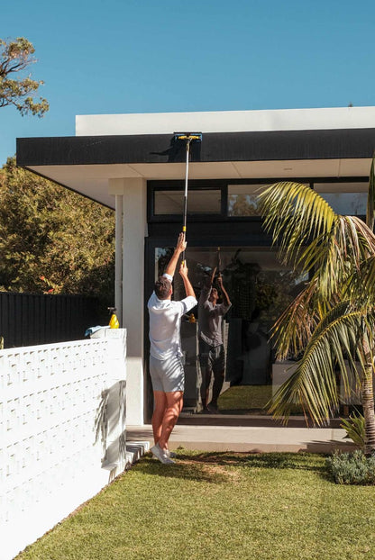Person cleaning outside with ENJO Telescopic Pole