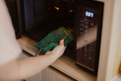 Person cleaning dirty microwave with ENJO Kitchen Mini