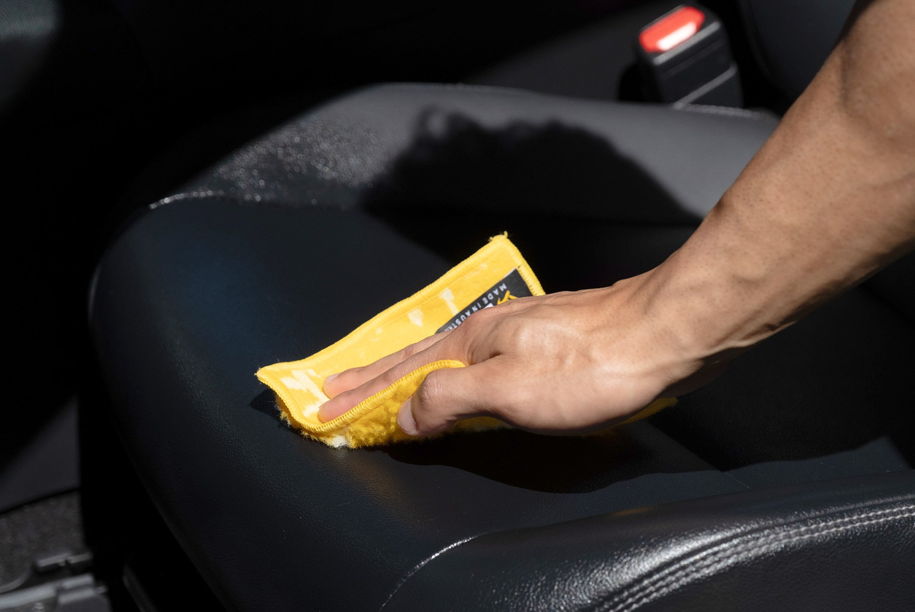 Person polishing car seat with ENJO Polishing Cloth