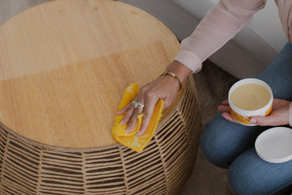 Person polishing coffee table with ENJO Polishing Cloth and ENJO Leather &amp; Wood Balm