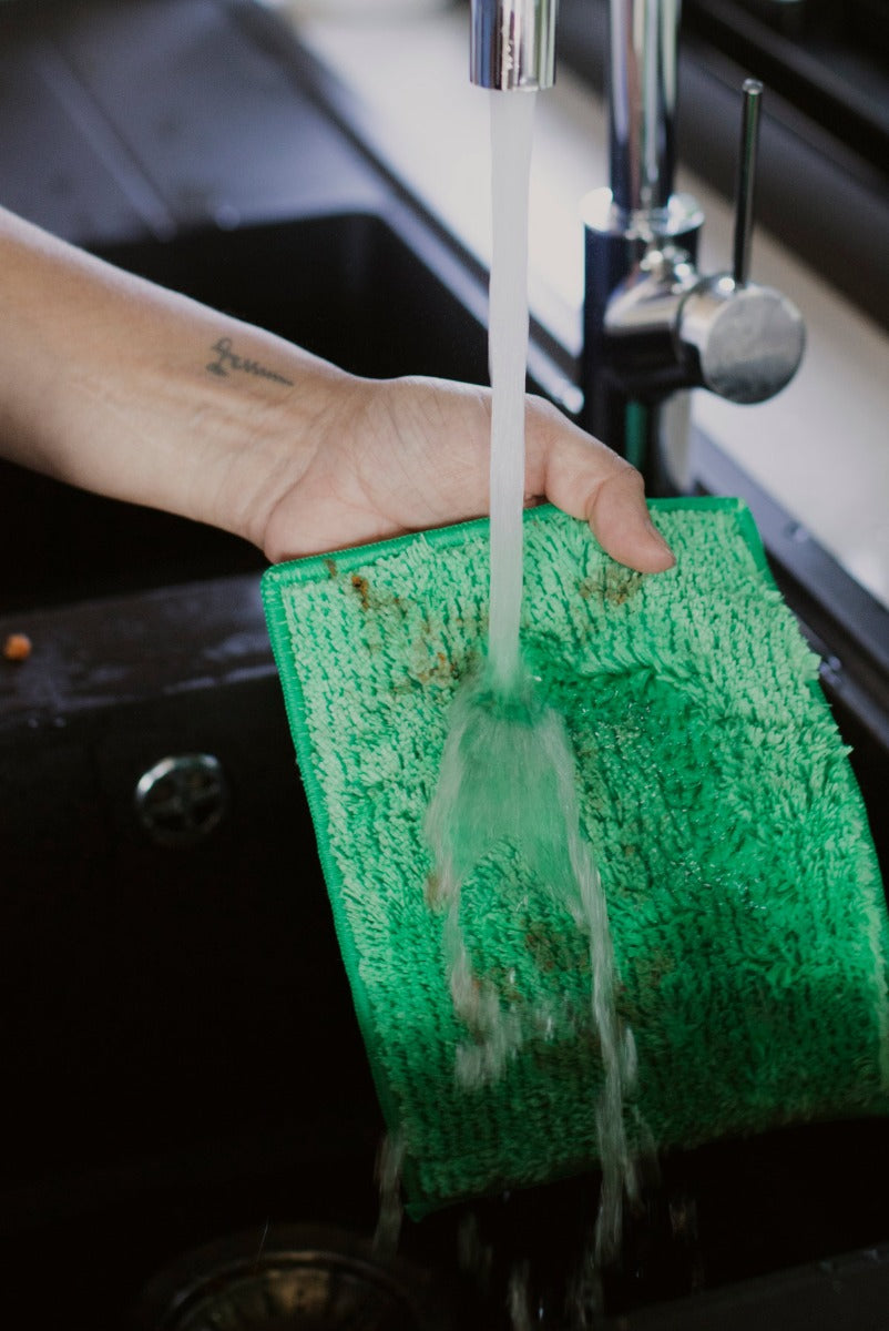 Person washing ENJO Kitchen Allpurpose Cloth under water in the sink