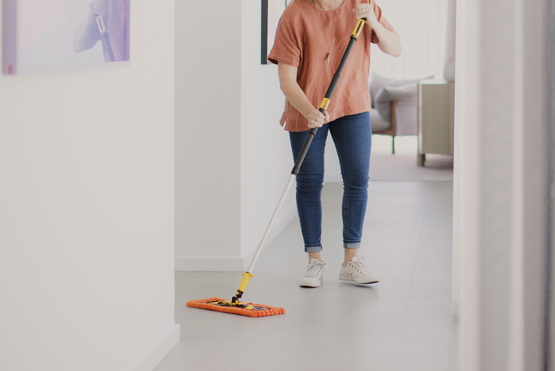A person sweeping a hallway with the ENJO Dust Fibre